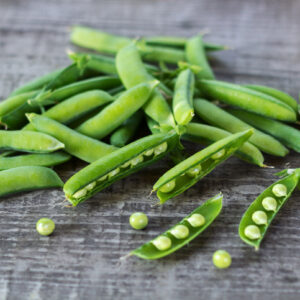 young juicy green peas on a wooden table